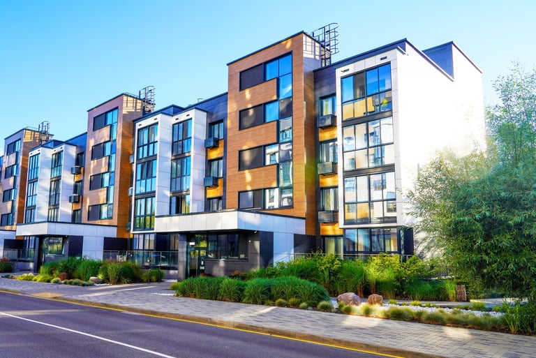 Modern residential apartment building representing investment properties and real estate portfolio growth